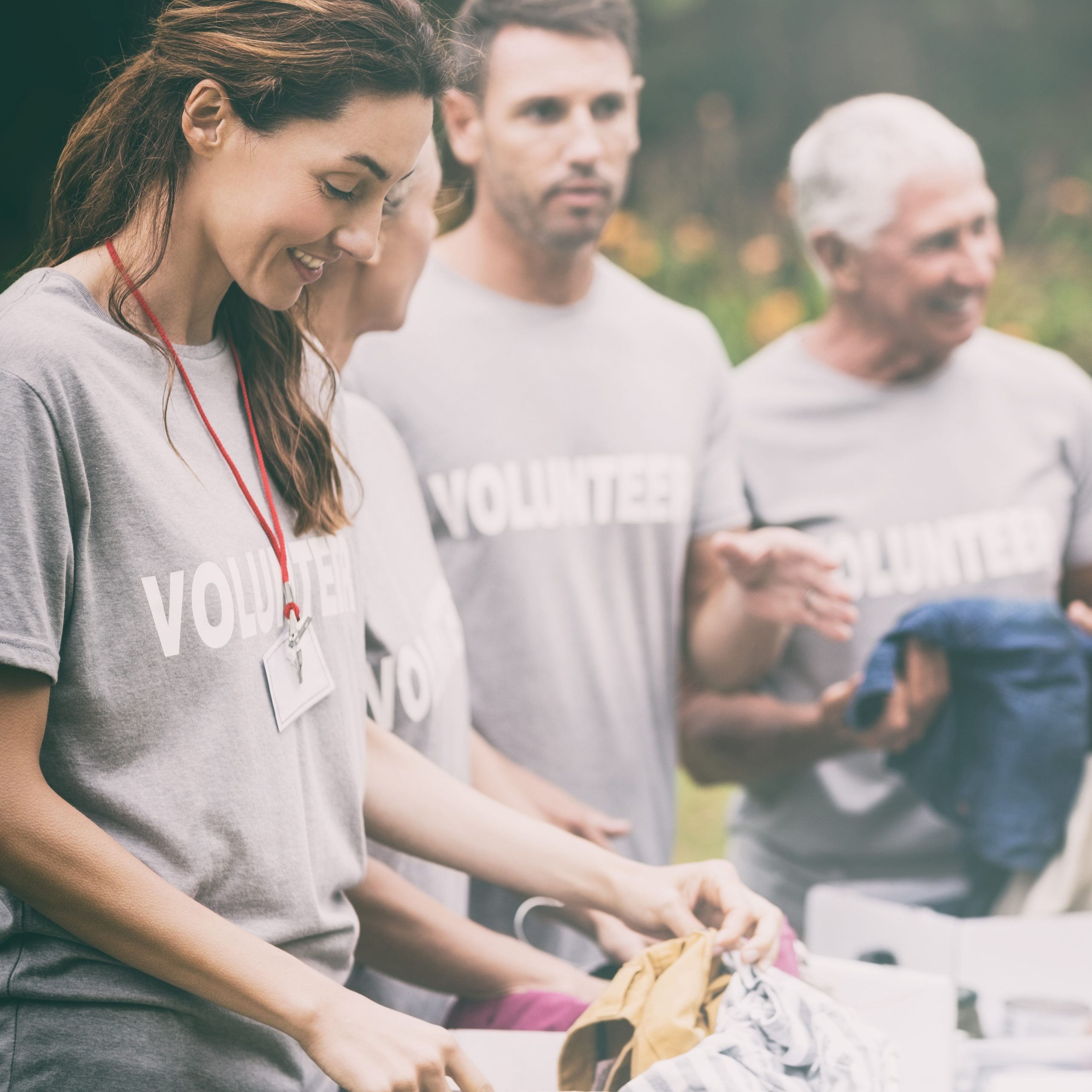 Happy volunteer looking at donation box