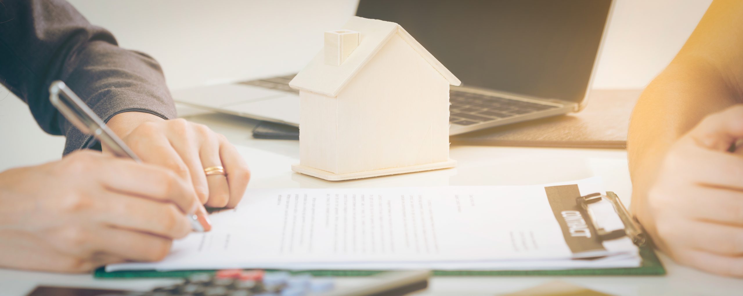 Client Signs Document to Buy House and Real Estate