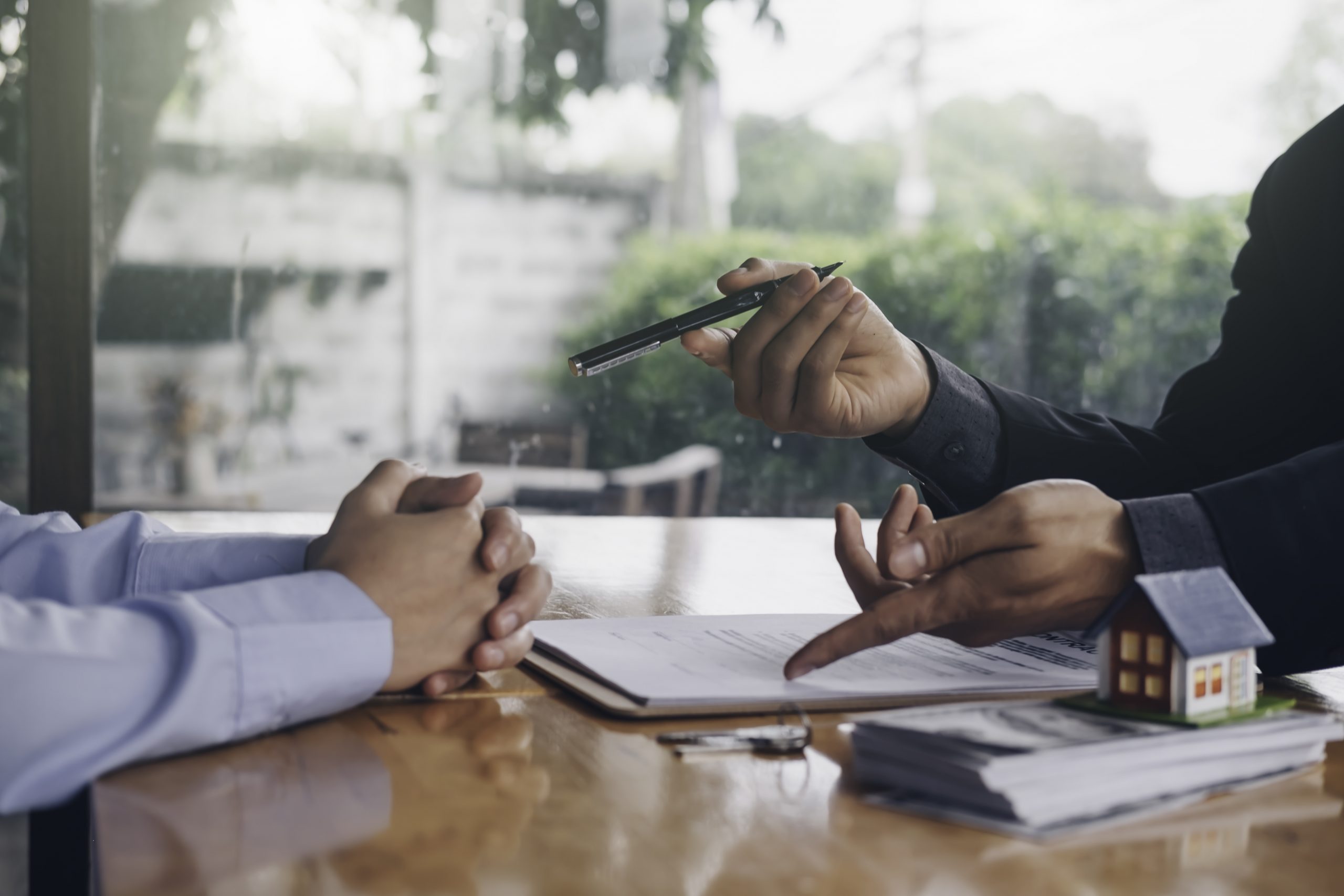 real estate agent holding house key to his client after signing contract,concept for real estate, moving home or renting property