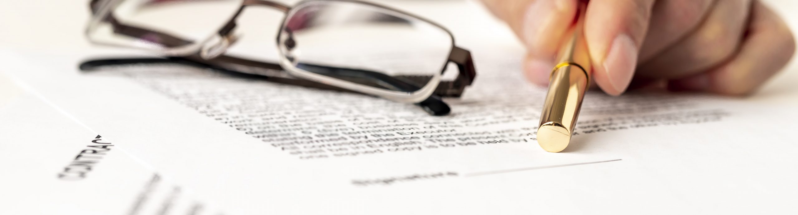 Businessman points on signature line on contract in office. Blurred documents and glasses. selective focus. Contract signing concept. Blurred text. Banner