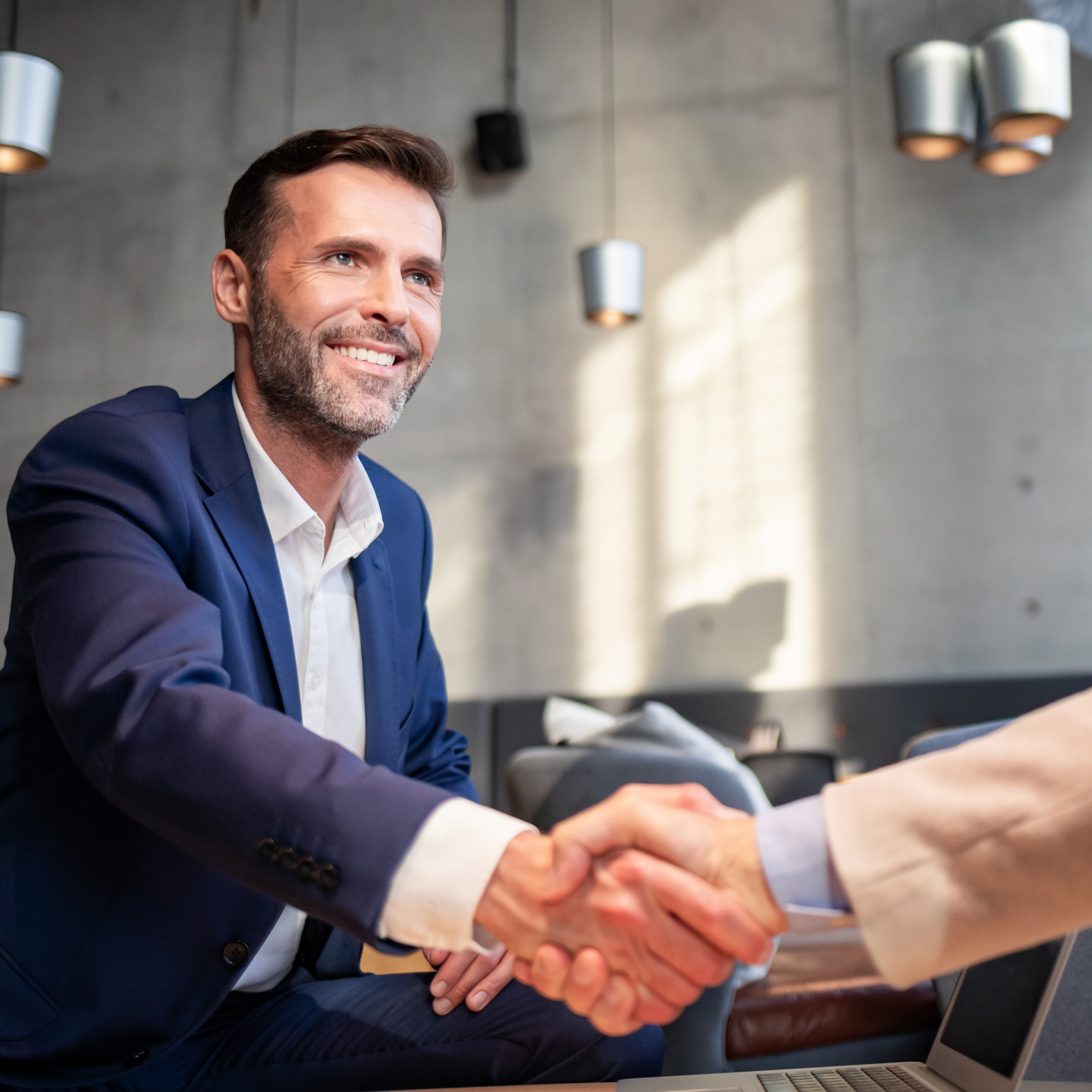Business people shaking hands during meeting in cafe